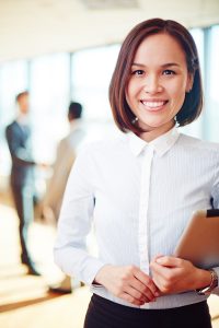 Successful business leader with touchpad looking at camera