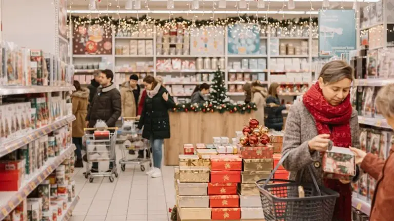 Busy retail store decorated for the holidays with shoppers browsing shelves