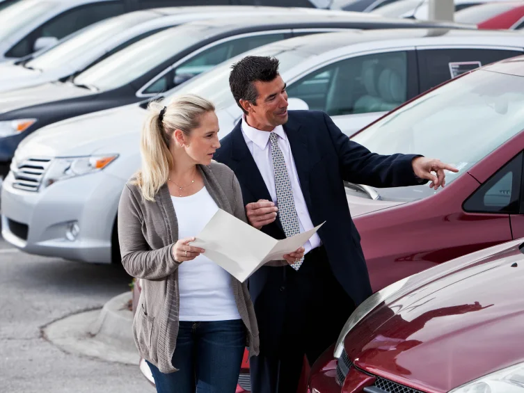 Dealer handing keys to a customer after a vehicle sale