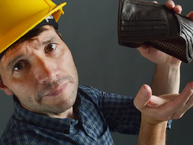 Subcontractor reviewing an unpaid invoice on a job site
