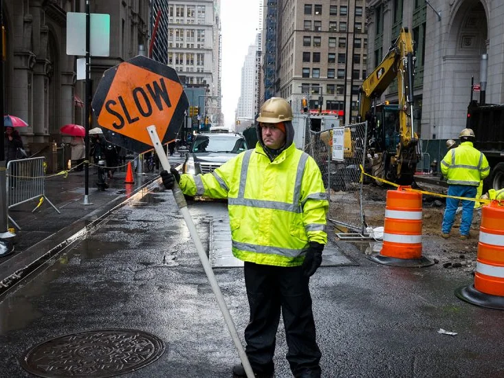 Construction worker on a permitted street obstruction job